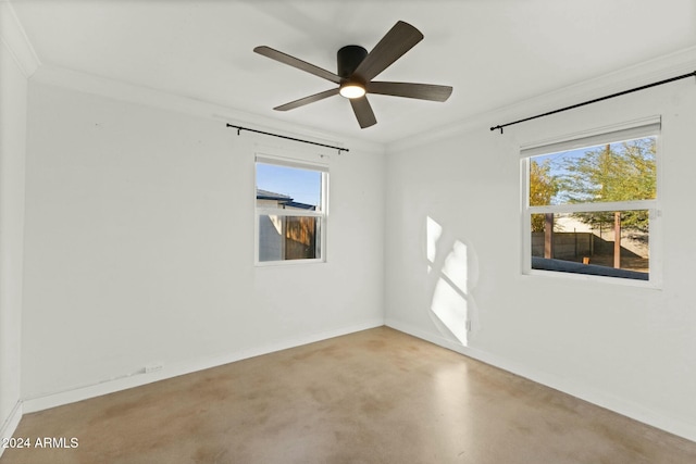 spare room with ceiling fan and crown molding