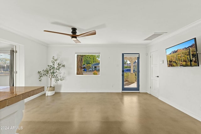 interior space with crown molding, ceiling fan, and concrete floors