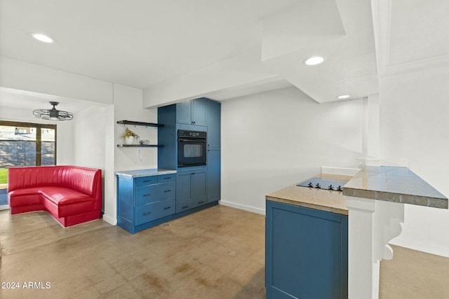 kitchen with kitchen peninsula, a breakfast bar, blue cabinets, and black appliances