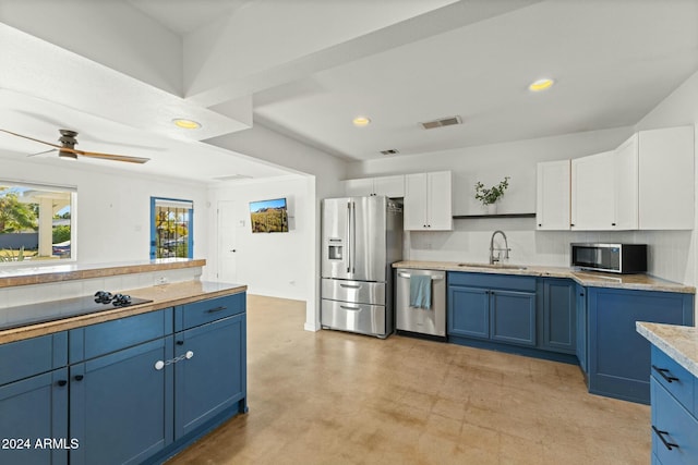 kitchen with blue cabinetry, sink, white cabinets, and stainless steel appliances