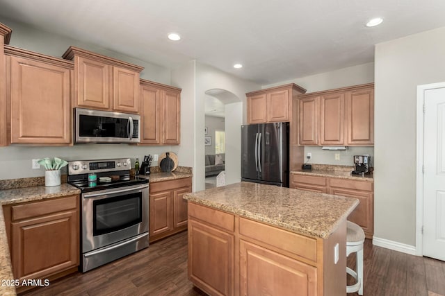 1429 E Lowell Ave, Gilbert, AZ 85295 - kitchen with appliances with stainless steel finishes, dark wood finished floors, arched walkways, a center island, and recessed lighting