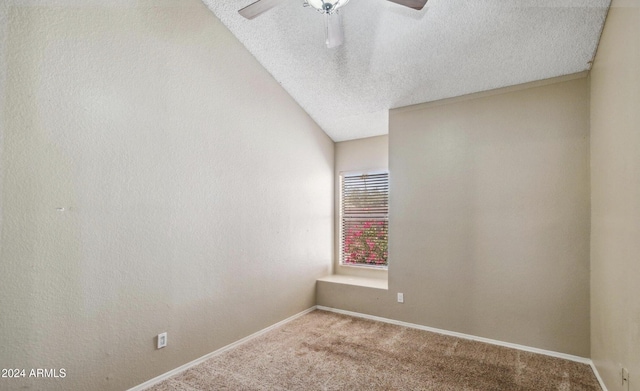 unfurnished room with vaulted ceiling, ceiling fan, light colored carpet, and a textured ceiling