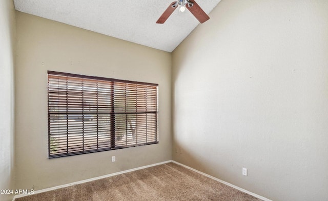 carpeted spare room with a textured ceiling, ceiling fan, and lofted ceiling