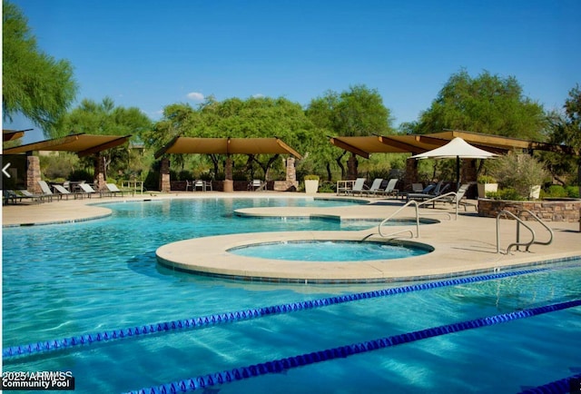 view of pool with a community hot tub and a patio area
