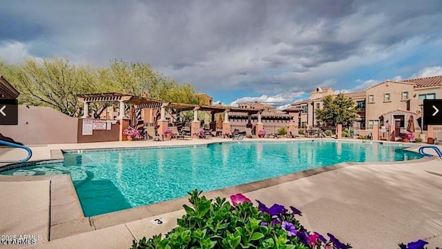 view of swimming pool featuring a pergola and a patio