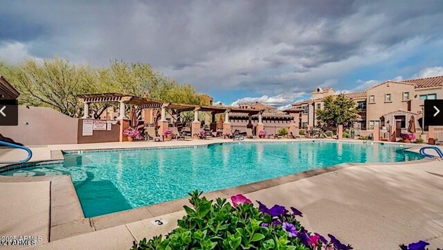 view of swimming pool featuring a pergola and a patio area