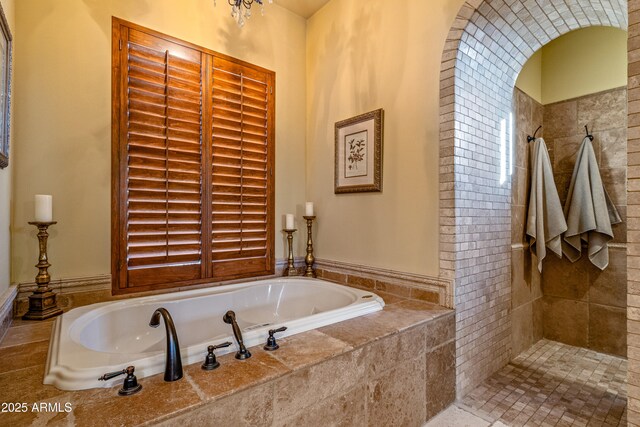 bathroom featuring separate shower and tub