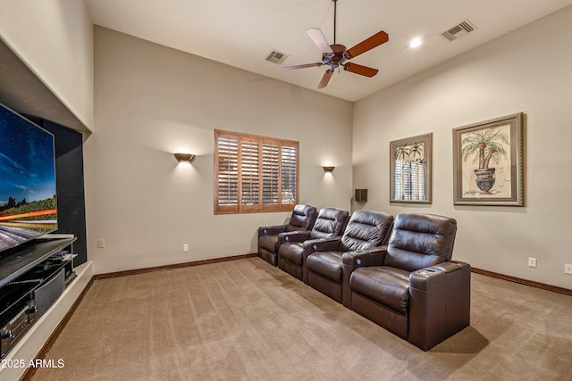 carpeted home theater with ceiling fan