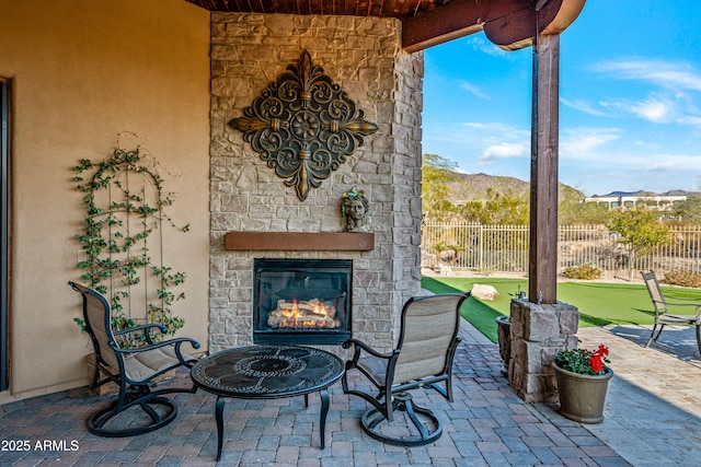 view of patio / terrace featuring an outdoor stone fireplace