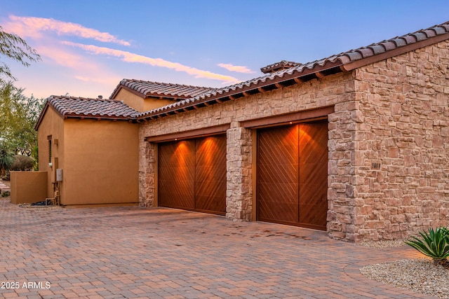 view of garage at dusk