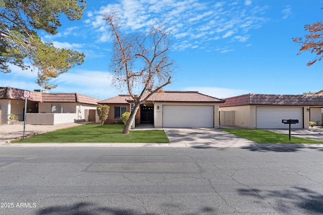 view of front facade featuring a tiled roof, a front lawn, and stucco siding