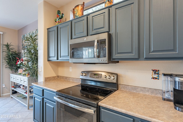 kitchen featuring appliances with stainless steel finishes and light tile patterned flooring