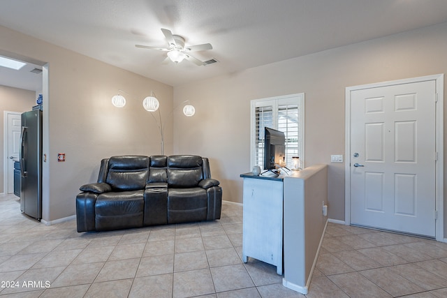 living room with ceiling fan and light tile patterned flooring