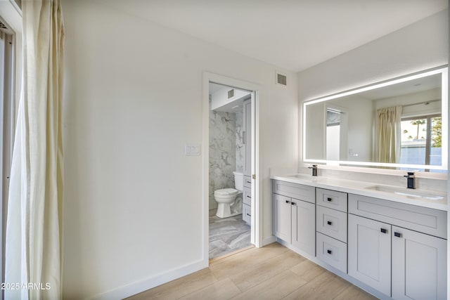 bathroom with vanity, hardwood / wood-style floors, and toilet