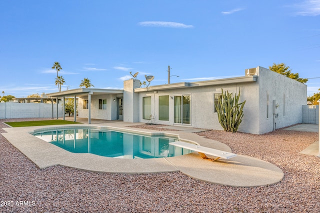 view of pool with a diving board and a patio area