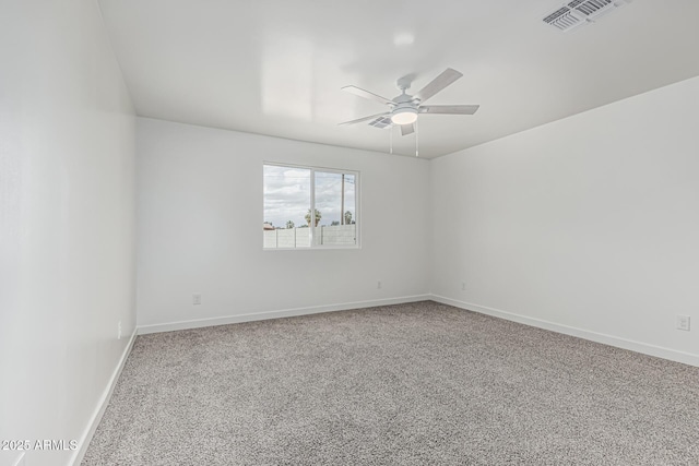 unfurnished room with carpet floors, visible vents, baseboards, and ceiling fan