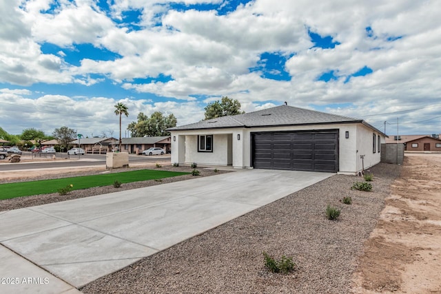ranch-style house featuring stucco siding, an attached garage, and driveway
