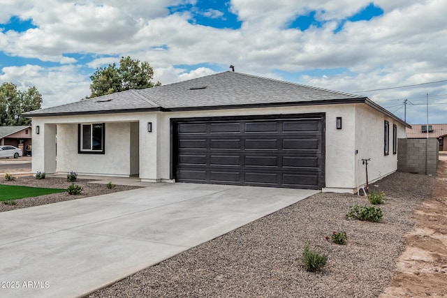 single story home with an attached garage, driveway, and stucco siding