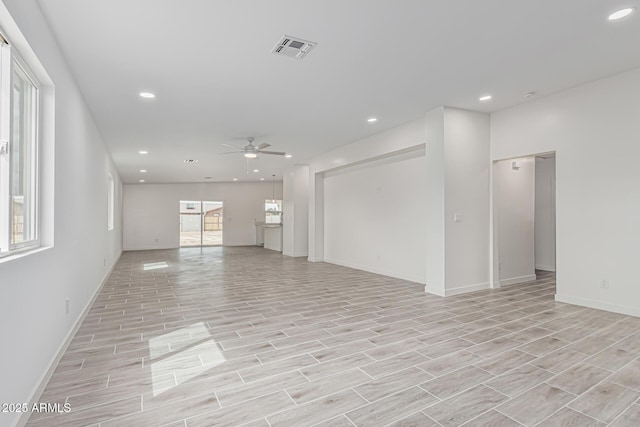 unfurnished living room featuring a ceiling fan, visible vents, wood finish floors, and recessed lighting