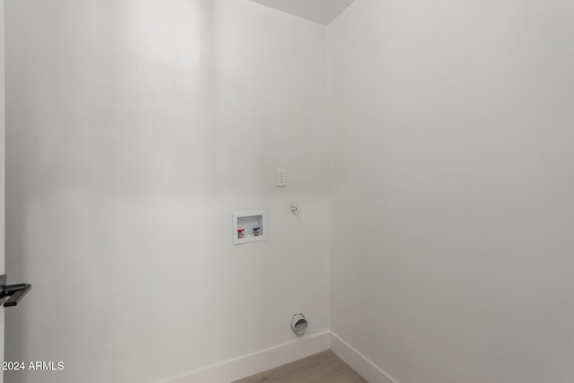 clothes washing area featuring light hardwood / wood-style floors and hookup for a washing machine