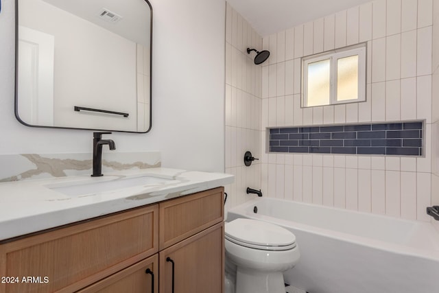 full bathroom with tiled shower / bath combo, toilet, and vanity