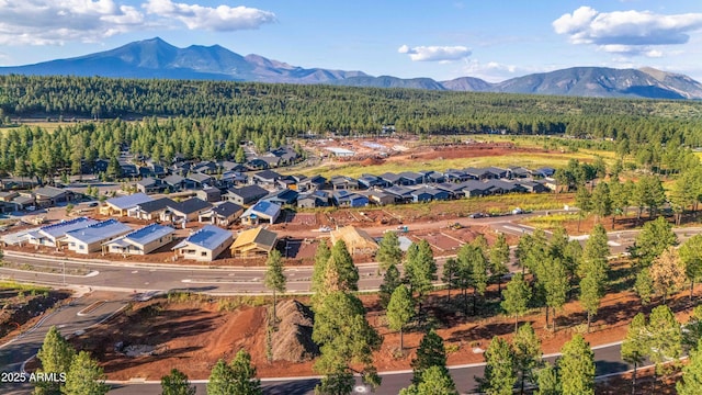 aerial view featuring a residential view, a mountain view, and a view of trees