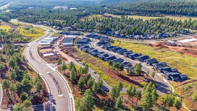 drone / aerial view featuring a residential view and a forest view