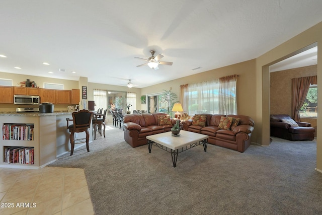 tiled living room featuring ceiling fan