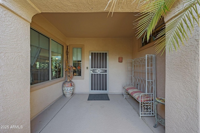 property entrance featuring a patio area