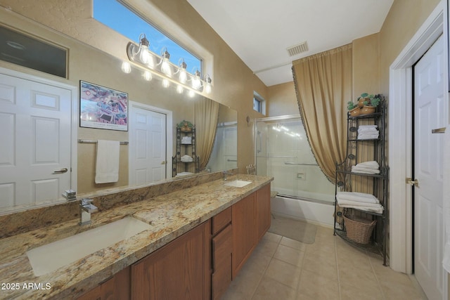 bathroom featuring tile patterned floors, combined bath / shower with glass door, and vanity