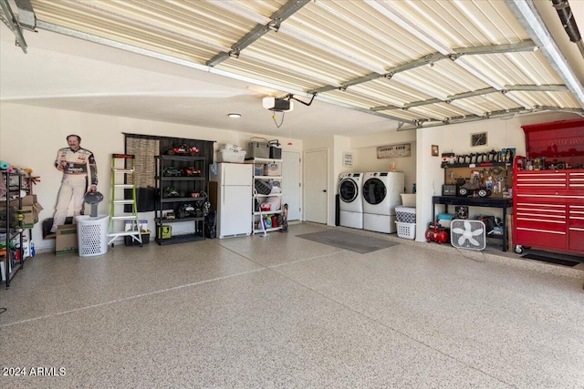 garage with white refrigerator, a garage door opener, and washer and dryer