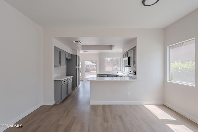101 N 7th St Unit 168, Phoenix, AZ 85034 - kitchen with white microwave, stove, light wood-type flooring, and light countertops