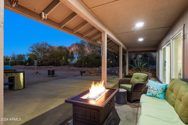 patio terrace at dusk featuring an outdoor living space with a fire pit