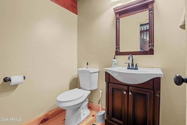 bathroom featuring hardwood / wood-style floors, toilet, and vanity