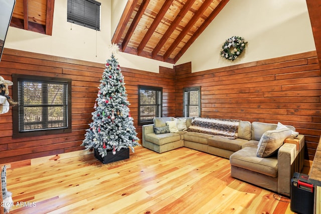 living room featuring wood ceiling, light hardwood / wood-style flooring, a wealth of natural light, and high vaulted ceiling