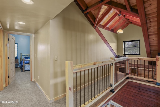 stairway featuring light colored carpet and vaulted ceiling