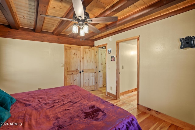 bedroom featuring light hardwood / wood-style floors, ceiling fan, wood ceiling, and beam ceiling