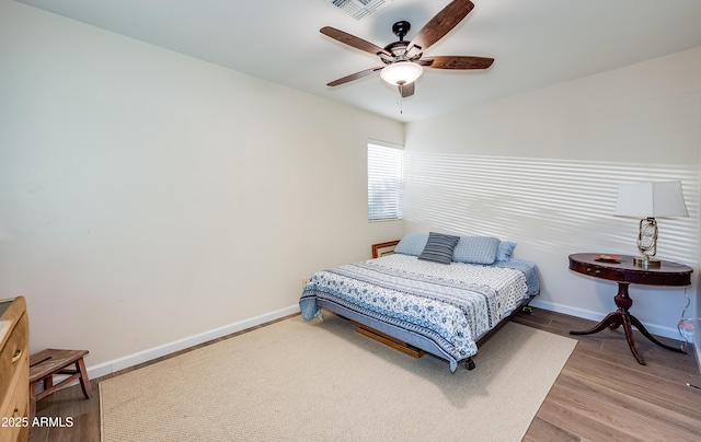7226 E Virginia Ave, Scottsdale, AZ 85257 - bedroom with baseboards, wood finished floors, and a ceiling fan