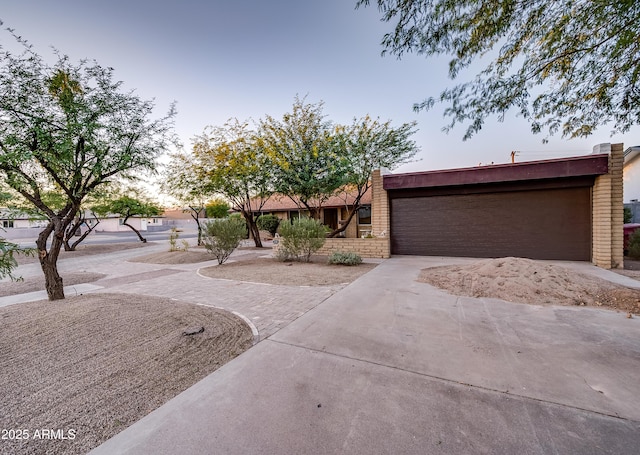 view of front of house with concrete driveway and brick siding