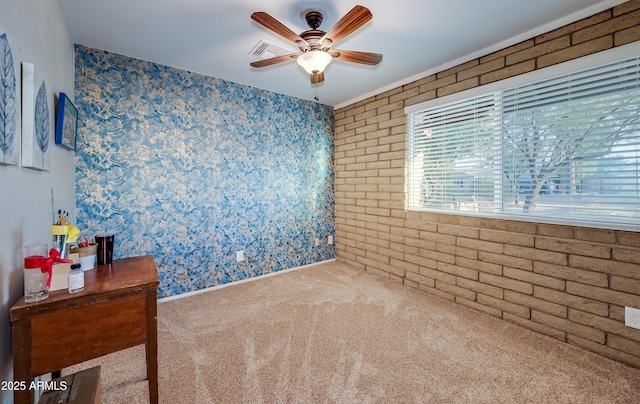 7226 E Virginia Ave, Scottsdale, AZ 85257 - spare room with carpet floors, a ceiling fan, wallpapered walls, and brick wall