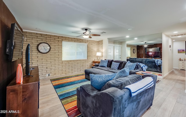 7226 E Virginia Ave, Scottsdale, AZ 85257 - living area featuring brick wall, ceiling fan, and light wood-style floors