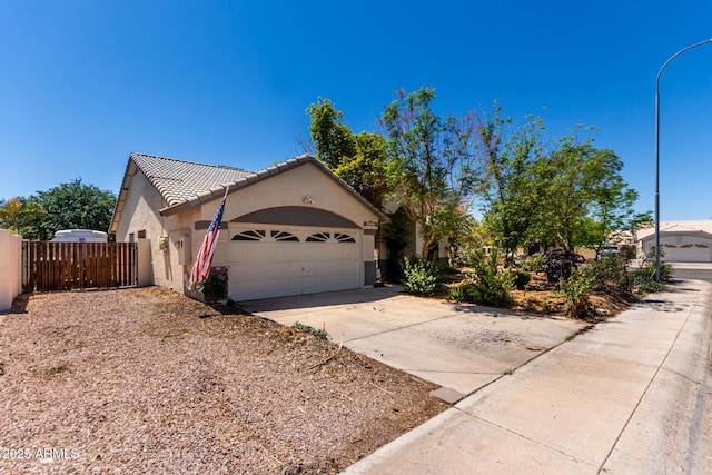 1915 E Golden Ct, Chandler, AZ 85225 - view of home's exterior featuring driveway, a tiled roof, an attached garage, fence, and stucco siding