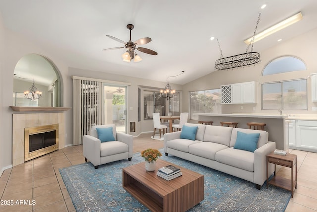 1915 E Golden Ct, Chandler, AZ 85225 - living area with a tile fireplace, vaulted ceiling, ceiling fan with notable chandelier, and light tile patterned floors