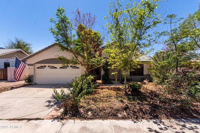 1915 E Golden Ct, Chandler, AZ 85225 - obstructed view of property featuring an attached garage, concrete driveway, a tiled roof, and stucco siding
