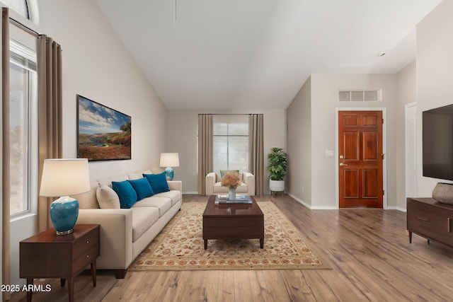 1915 E Golden Ct, Chandler, AZ 85225 - living area featuring wood finished floors, visible vents, lofted ceiling, and baseboards