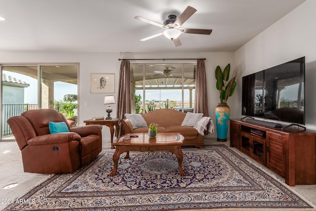 living room with ceiling fan and light colored carpet