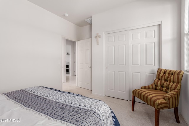 bedroom with a closet and light colored carpet