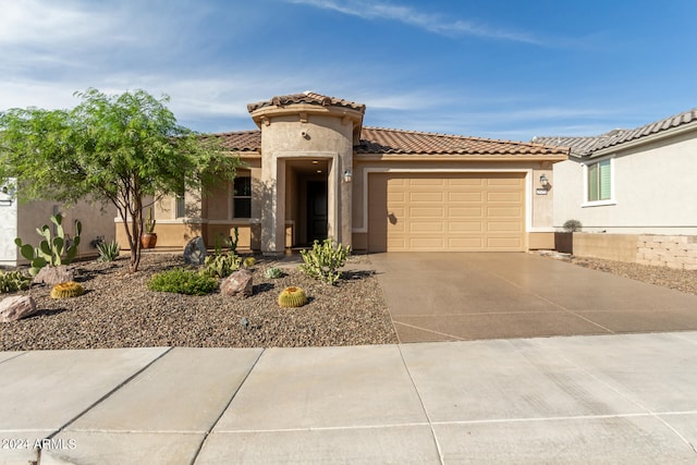 mediterranean / spanish-style home featuring a garage