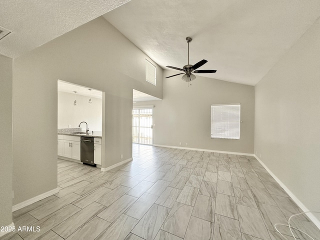 unfurnished living room featuring lofted ceiling, sink, a textured ceiling, and ceiling fan