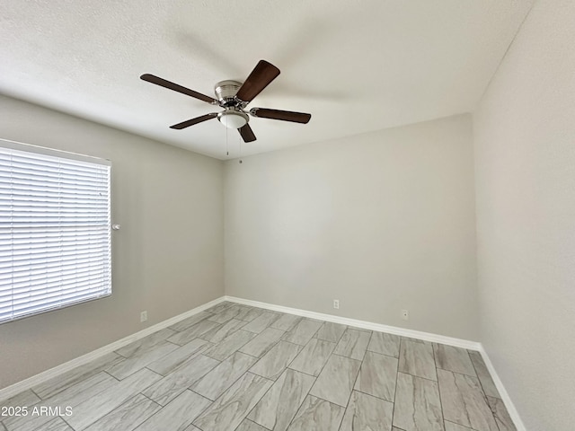 unfurnished room with a textured ceiling and ceiling fan